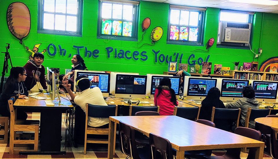 Kids working on desktop computers.